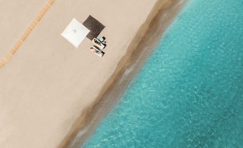 Ikos Resorts_Couple relaxing on the beach_792x484